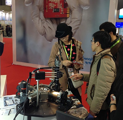 Show attendees examining a Lake Shore probe station