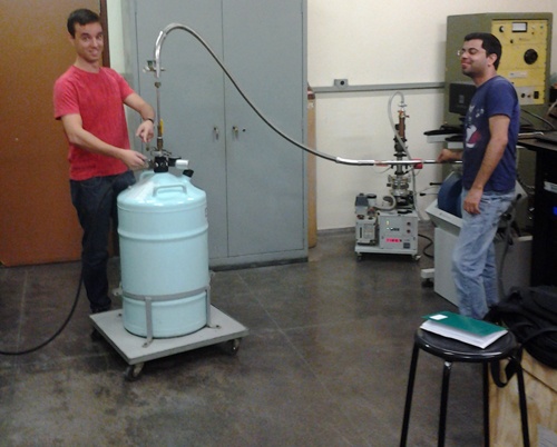 Post-doctoral students, Eduardo R de Lascio and Hardeep Kumar perform the first liquid helium transfer for the new Lake Shore VSM.